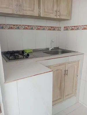 a white kitchen with a sink and a stove at CABAÑAS CALIPSO, 2 piso in Coveñas