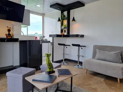 a living room with a couch and a table at Studio Apartment Old City Cartagena Almirante in Cartagena de Indias
