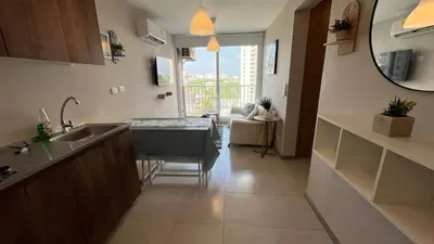 a kitchen with a sink and a table in a room at Apto bien ubicado cerca al mar, cerca al centro y al aereopuerto in Cartagena de Indias