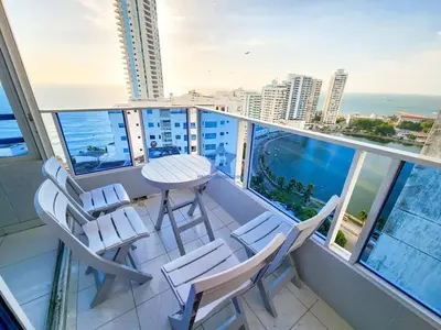 a balcony with a table and chairs and the ocean at Apartamento Piso 18 Blue Horizon in Cartagena de Indias
