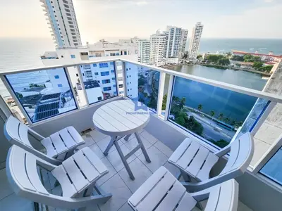 a balcony with a table and chairs and the ocean at Apartamento Piso 18 Blue Horizon in Cartagena de Indias