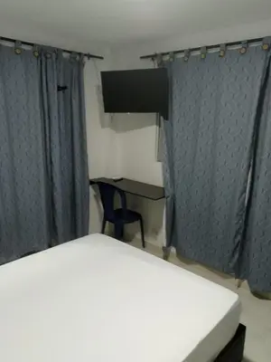 a bedroom with a bed and a desk with a chair at Hotel Villa Marta Cartagena in Cartagena de Indias