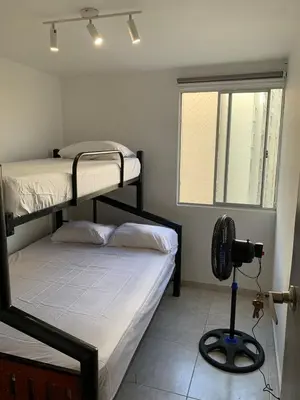 two bunk beds in a room with a camera at Apartamento acogedor in Barranquilla