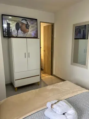 a bedroom with a flat screen tv on a wall at Sunset 47 mar y vida in Cartagena de Indias
