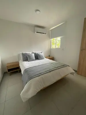 a bedroom with a large bed in a white room at Sunset 47 mar y vida in Cartagena de Indias