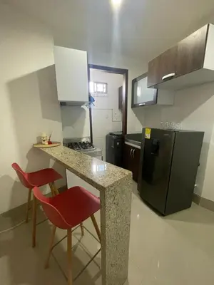 a small kitchen with a counter and a refrigerator at Excelente apartaestudio in Sincelejo