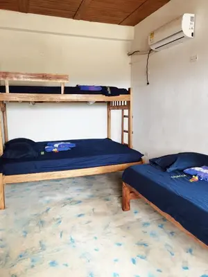 a room with two bunk beds and a fan at Cabaña Alojamiento Valhalla in Rincón