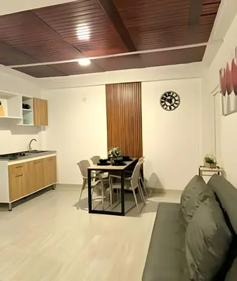 a living room with a couch and a table at Apartamento cerca a la playa y al mar Punta Roca in Maizal
