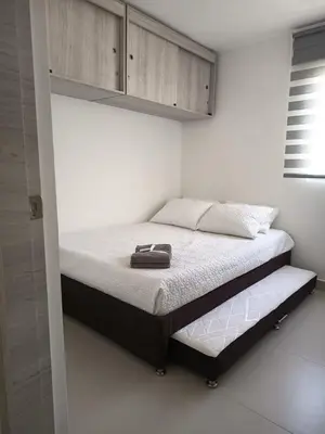 a bed in a white room with at B lounge experience ctg bolívar in Cartagena de Indias