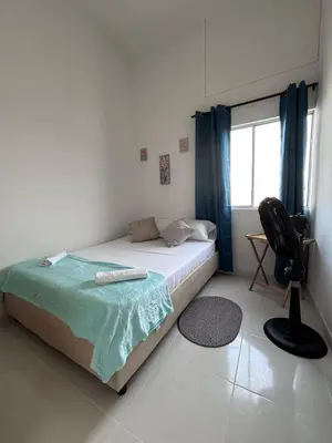 a bedroom with a bed and a chair and a window at B lounge experience ctg bolívar in Cartagena de Indias