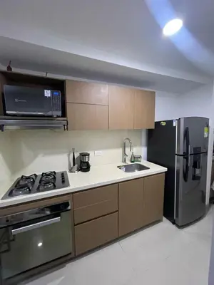 a kitchen with a stove and a refrigerator at Apartaestudio 91 in Barranquilla
