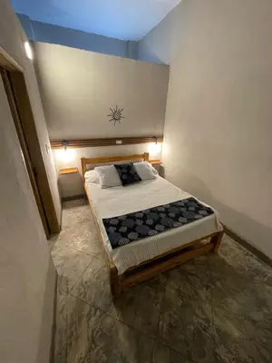 a small bedroom with a bed in a room at Terraza Del Sol in Coveñitas