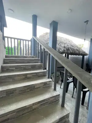 a set of stairs in a house with a table and chairs at Terraza Del Sol in Coveñitas