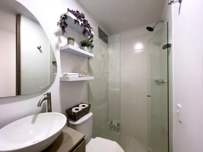 a bathroom with a sink and a toilet and a mirror at Cozy and close to the airport in Cartagena de Indias