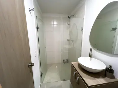 a bathroom with a sink and a shower with a mirror at Cozy and close to the airport in Cartagena de Indias