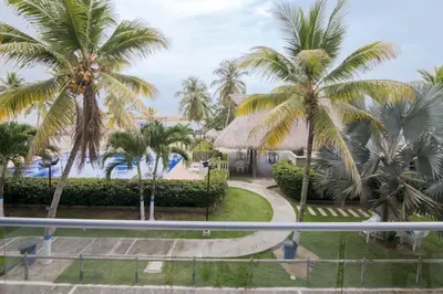 a view of a resort with palm trees and a pool at Hermoso Apartamento Frente al Mar 2 Habitaciones PAZ127 in Coveñas