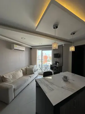 a living room with a couch and a table at Luxury 14th floor with amazing view in Barranquilla