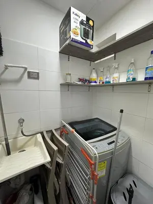 a laundry room with a washing machine and a sink at Luxury 14th floor with amazing view in Barranquilla