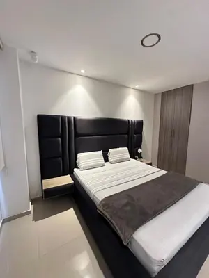 a bedroom with a large bed with a black headboard at Luxury 14th floor with amazing view in Barranquilla