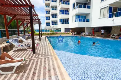 a swimming pool at a hotel with people swimming in it at Apartamento Vista Panorámica - Piso 20 in Cartagena de Indias