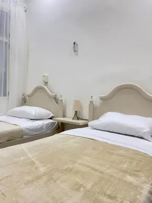 a white bedroom with two beds and a window at Apartamento en Centro histórico de Cartagena in Estación El Salto