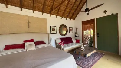 a bedroom with a large bed and a couch at Hacienda San Benito in Cartagena de Indias