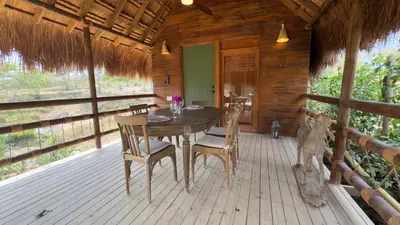 a dining room with a table and chairs on a porch at Hacienda San Benito in Cartagena de Indias