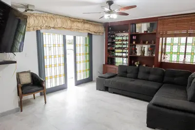 a living room with a couch and a tv at Casa Gaitán Beach and comfort by the sea in Cartagena de Indias