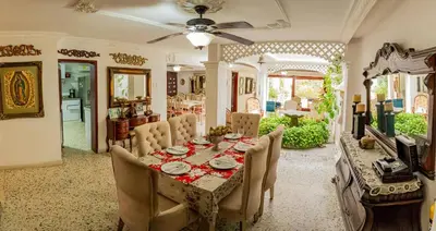 a dining room with a table and chairs at Casa Gaitán Beach and comfort by the sea in Cartagena de Indias