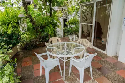 a glass table and chairs on a patio at Casa Gaitán Beach and comfort by the sea in Cartagena de Indias