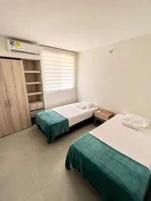 a bedroom with two beds and a window in it at 