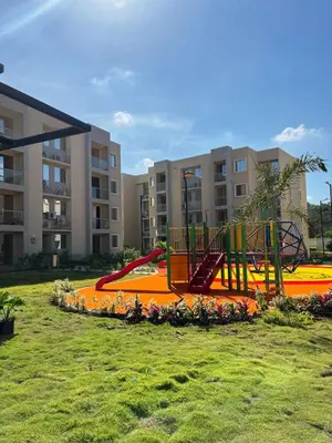 a playground in front of a apartment complex at 