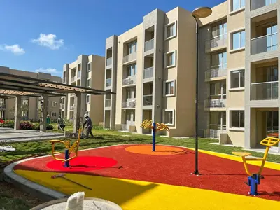 a playground in front of a apartment building at 
