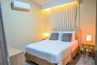a bedroom with a bed with two pillows on it at Hotel Bahía Azul Manga Cartagena in Cartagena de Indias