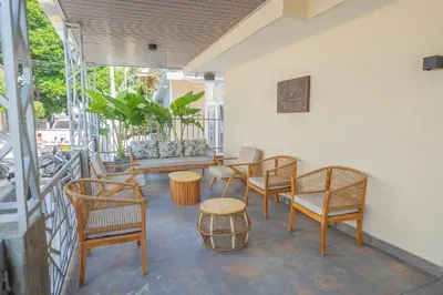a group of chairs and tables on a balcony at Hotel Bahía Azul Manga Cartagena in Cartagena de Indias