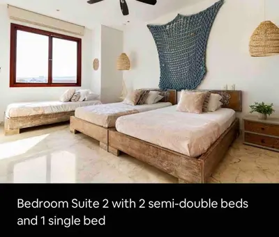 two beds in a bedroom with twotemp double beds and i single bed at Charming Cartagena Apartment Your Perfect Getaway in Cartagena de Indias