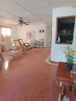 a living room with chairs and a table at Beach Airport House in Cartagena de Indias