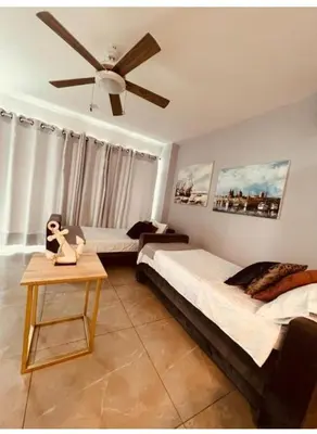 a bedroom with two beds and a ceiling fan at Luxurious, modern apartment in Cartagena Morros 3 in Cartagena de Indias