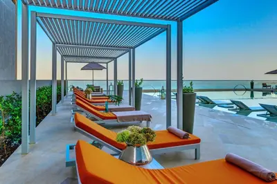 a group of chairs and tables on a patio at Luxurious and modern oceanfront apartment with views of the historic city 2B and 2BR in Cartagena de Indias