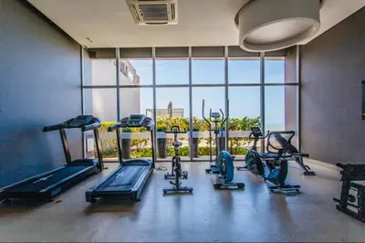 a gym with several treadmills and a large window at Luxurious and modern oceanfront apartment with views of the historic city 2B and 2BR in Cartagena de Indias