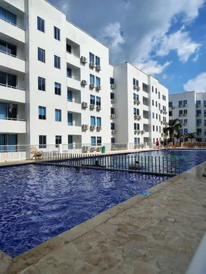 a swimming pool in front of a building at Acojedor apto en coveñas in Coveñas