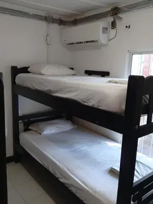 two bunk beds in a room with a window at Shantyhostal in Cartagena de Indias
