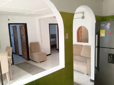 a room with chairs and a refrigerator in it at Shantyhostal in Cartagena de Indias