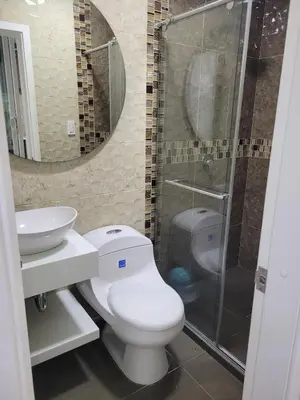 a bathroom with a toilet and a sink and a shower at Aparta estudio Malecón del Río in Barranquilla