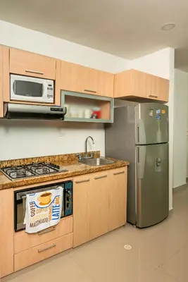 a kitchen with a sink and a refrigerator at Magico Apartamento Frente al Mar 2 Habitaciones B11B in Coveñitas