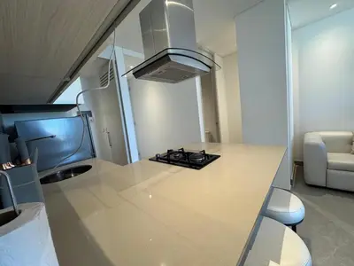 a kitchen with a counter top with a stove at Hermosa y Comoda Suite en Distrito 90 in Barranquilla