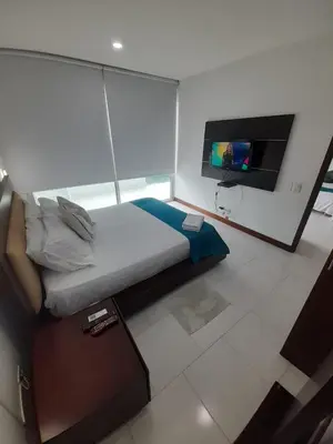 a bedroom with a bed and a flat screen tv at Apartamento vista al mar cartagena Edificio Morros in Cartagena de Indias