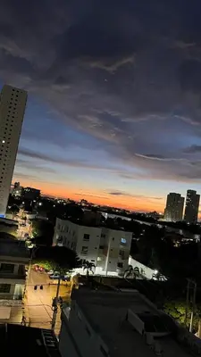 a view of a city at sunset with buildings at Alojamiento cerca del centro histórico y de la playa in Estación El Salto