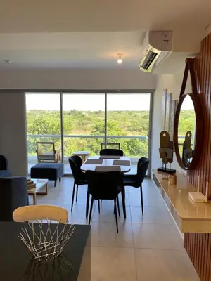 a living room with a table and some chairs at Castelo - Serena Del Mar in Puerto Tierrabaja