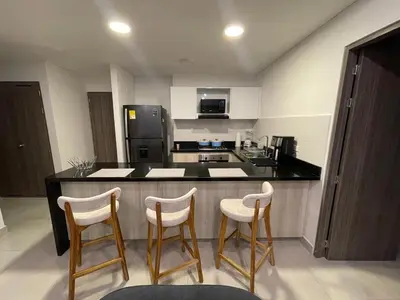 a kitchen with three bar stools and a counter top at Castelo - Serena Del Mar in Puerto Tierrabaja